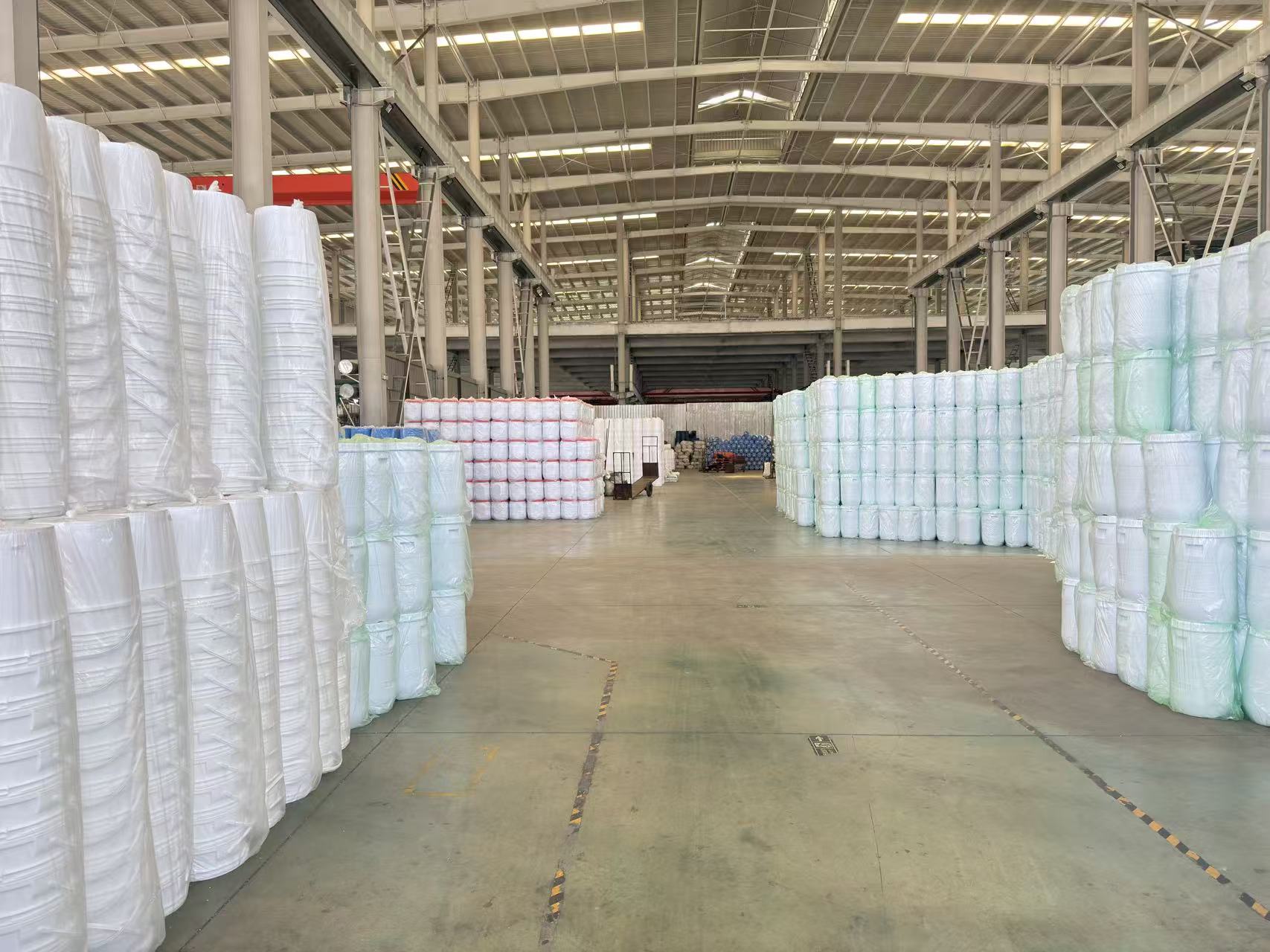 Warehouse fully stocked with finished blow molded plastic barrels and containers bulk inventory